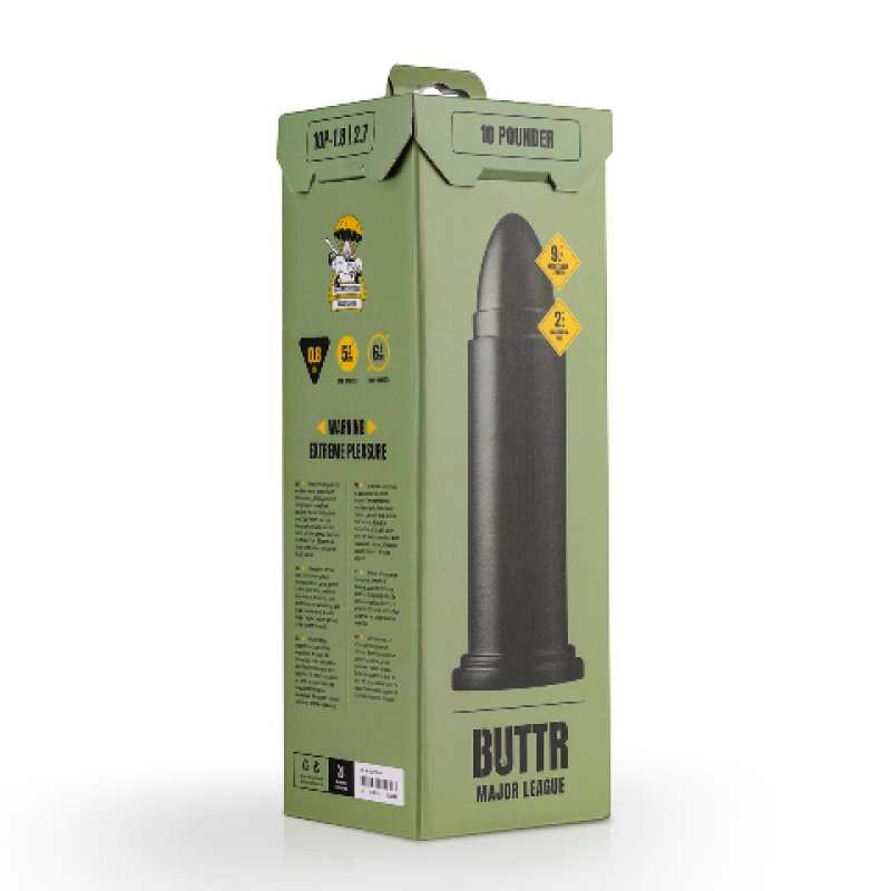 A tall rectangular product box in muted olive green with a large black bullet graphic on the front, plus yellow warning-style icons and the text 'BUTTR MAJOR LEAGUE' near the bottom. No person, animal, or real environment is present, so this is Product/Packaging.